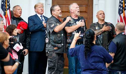 Snopes Debunks Claim That Trump Posed With Bikers With Nazi Tattoos on Charlottesville Anniversary [Corrected]